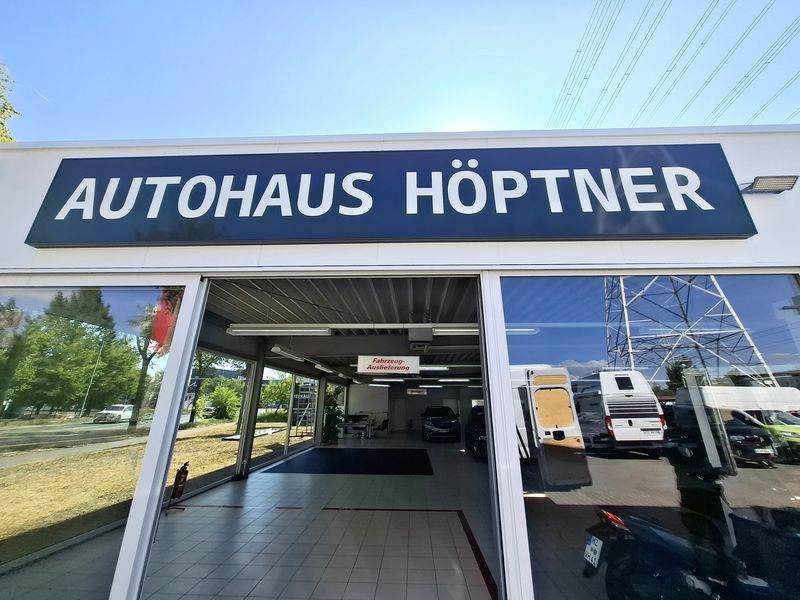 Der vollendete Leuchtkasten des Autohauses Höptner sorgt für eine starke Sichtbarkeit und einen modernen Außenauftritt  mit der Aufschrift Autohaus Höptner über der Glasfront.